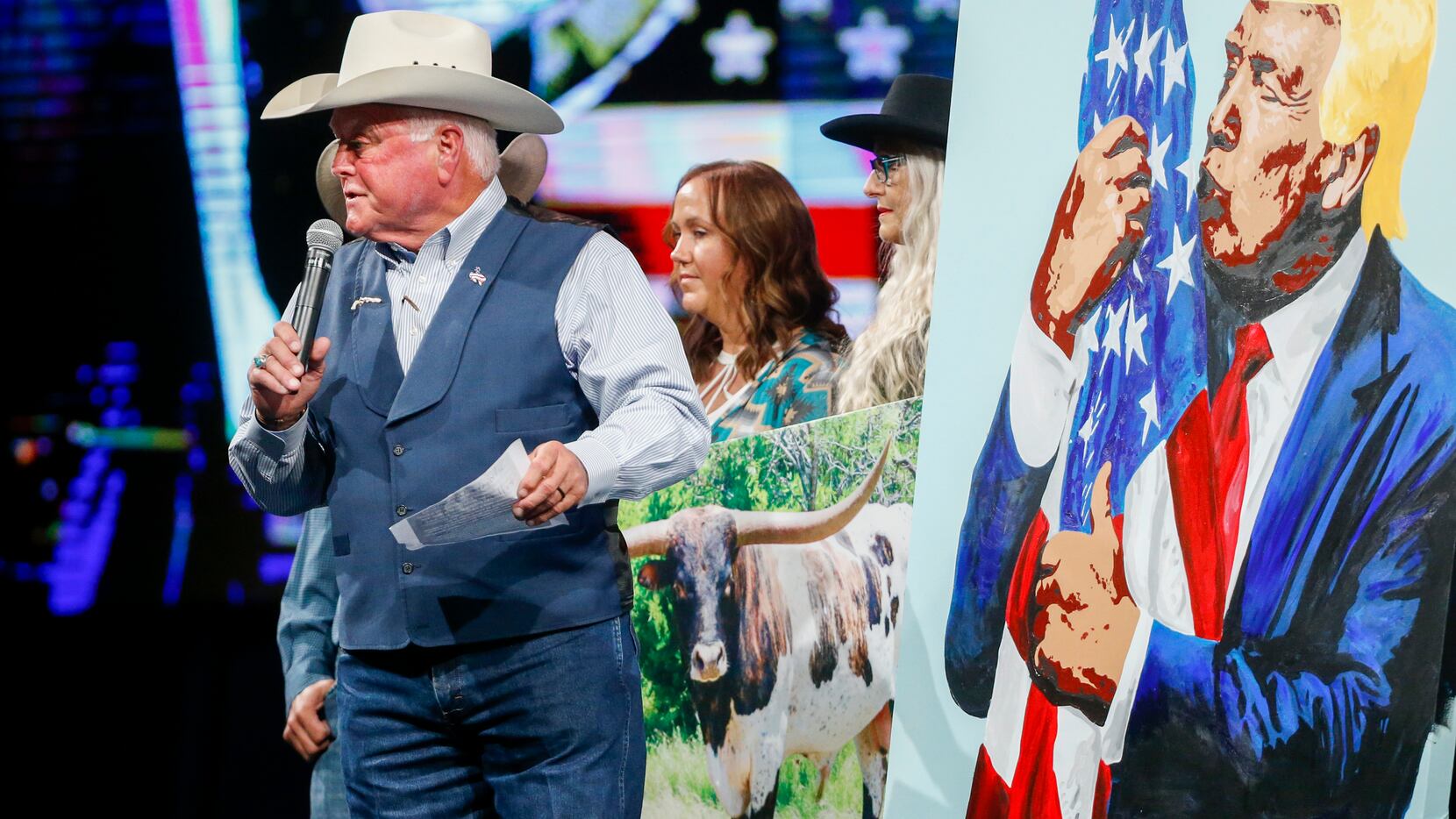 Texas Agriculture Commissioner Sid Miller calls an auction for a painting of former...
