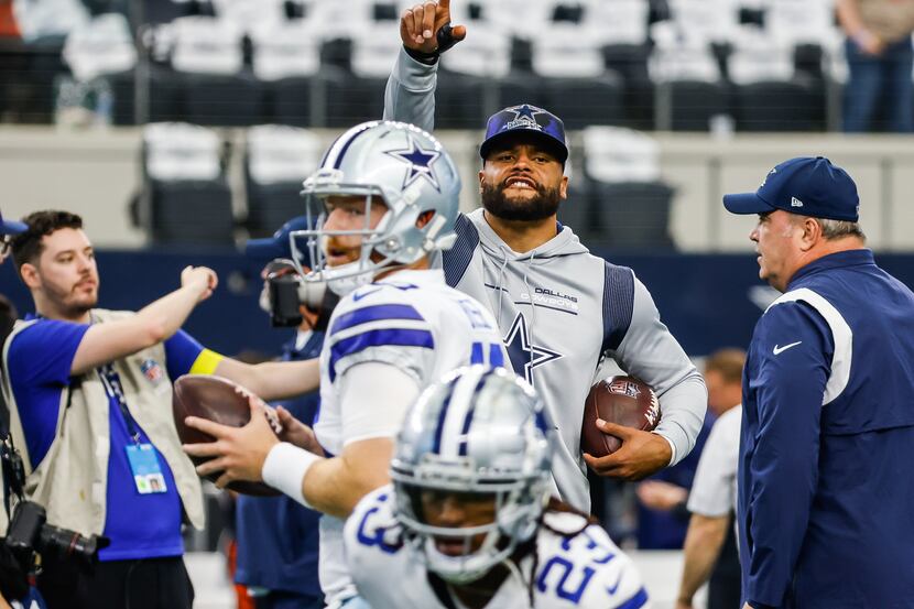 Dallas Cowboys quarterback Dak Prescott (4) watches quarterback Cooper Rush (10) during...