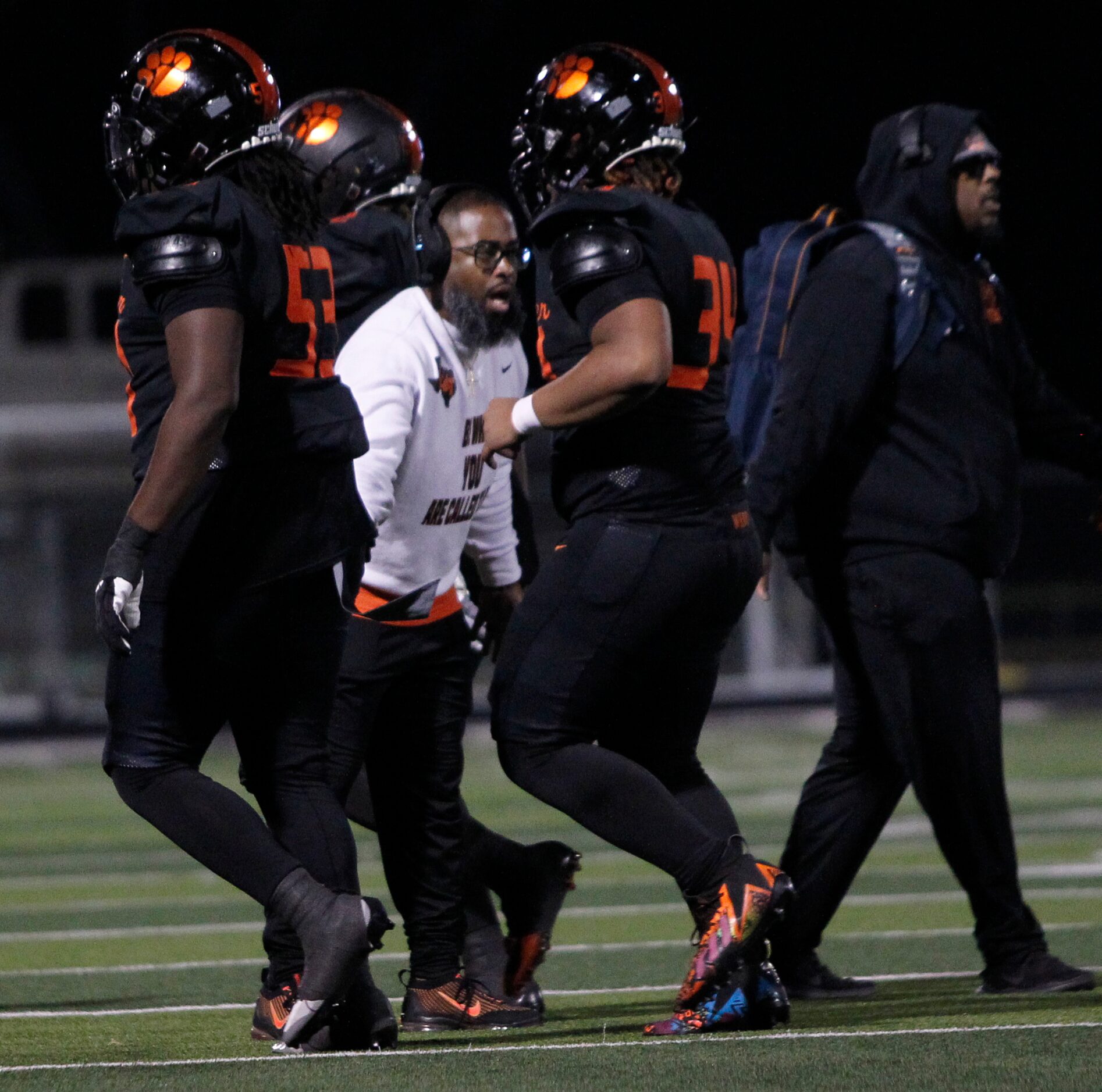 Lancaster head coach Leon Paul, center, greets his players after a score during the first...