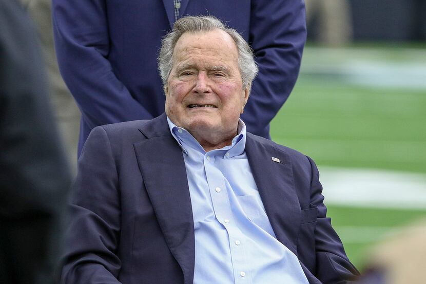 Former President George H.W. Bush poses with Houston Texans owner Bob McNair during pregame...