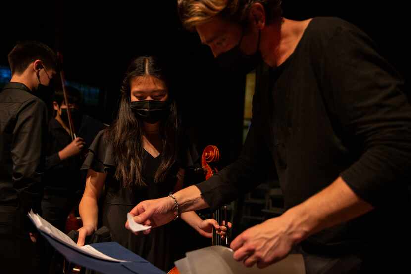 Linda Chen goes over sheet music with Texas Cellos director Joseph Kuipers.