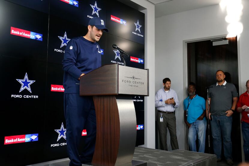 Dallas Cowboys quarterback Tony Romo reads a statement during a press conference at Ford...