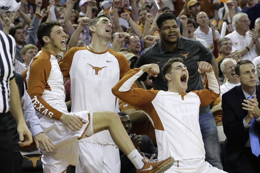 Texas forward Ryan McClurg (30) and teammates celebrate from the bench during the second...