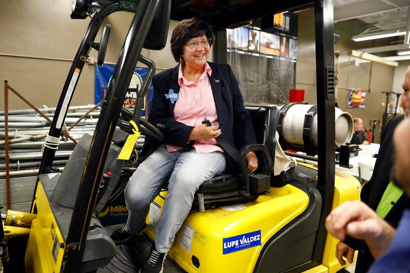 Democratic gubernatorial candidate Lupe Valdez sits in a forklift bearing one of her...