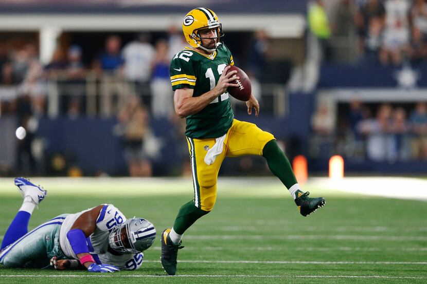 Green Bay Packers quarterback Aaron Rodgers (12) shakes Dallas Cowboys defensive tackle...