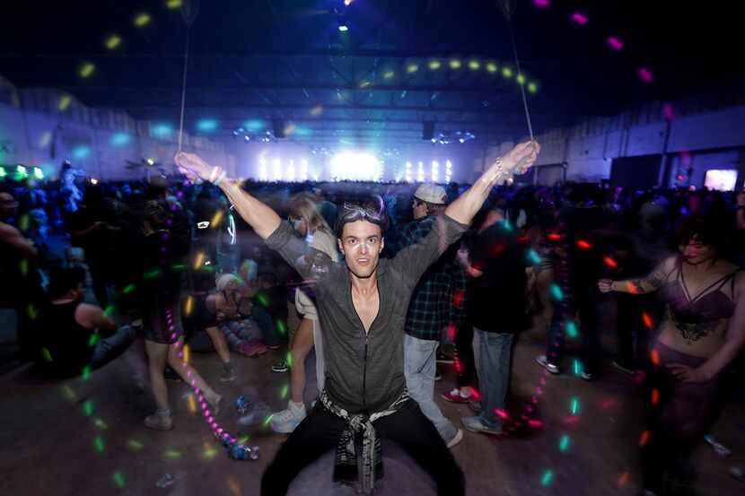 Jason Booher dances to the music during the Lights All Night music festival at Dallas Market...