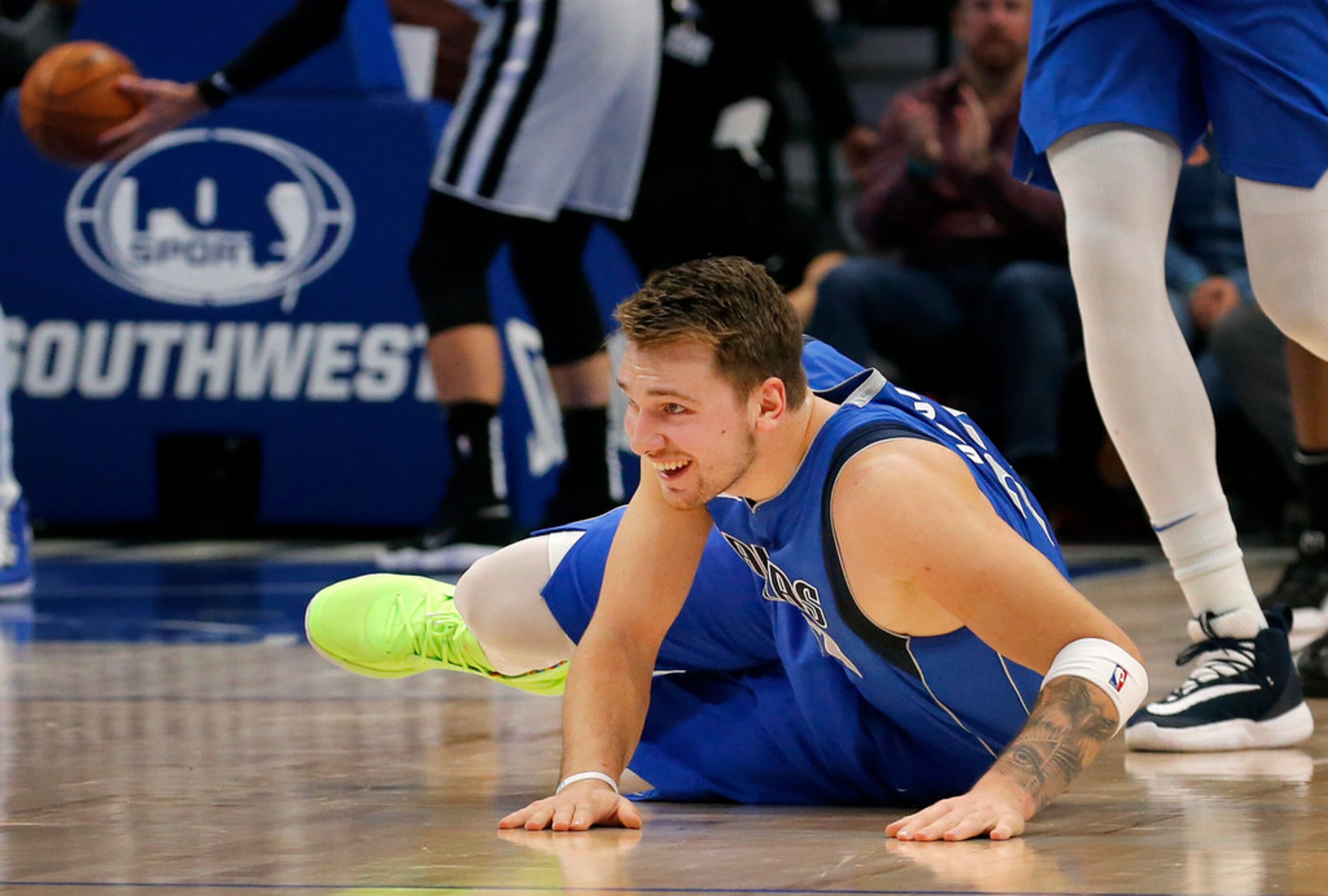 Dallas Mavericks forward Luka Doncic (77) laughs after falling down following his first half...