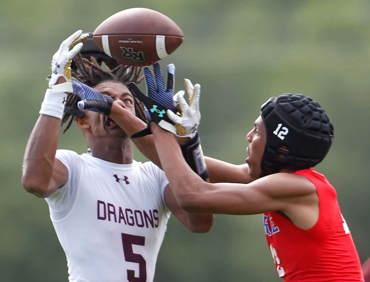 Midlothian Heritage defender Marcus Green (12), right, breaks up a long pass intended for a...