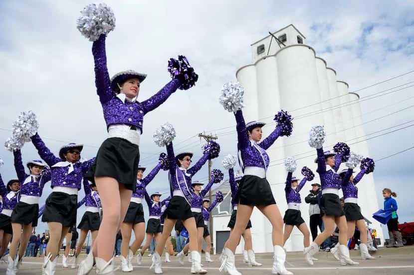 The Independence High School drill team marches in the Frisco Community Parade along Main...