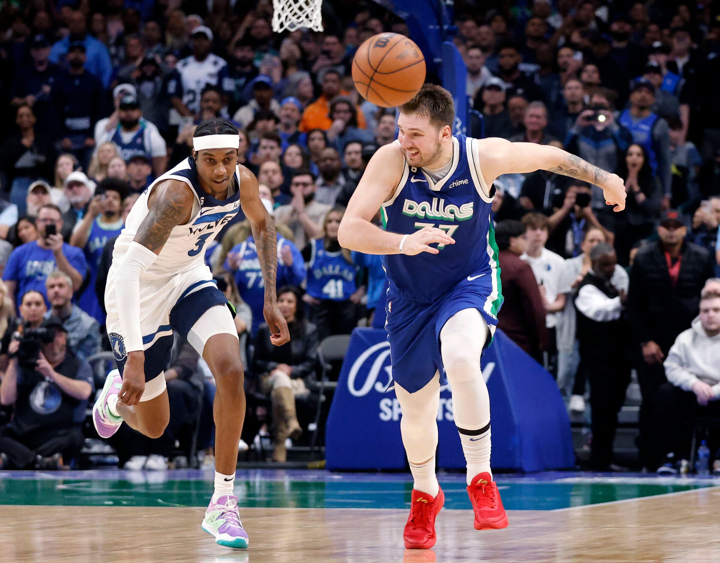 Dallas Mavericks guard Luka Doncic (77) chases down the ball after having it  knocked away...