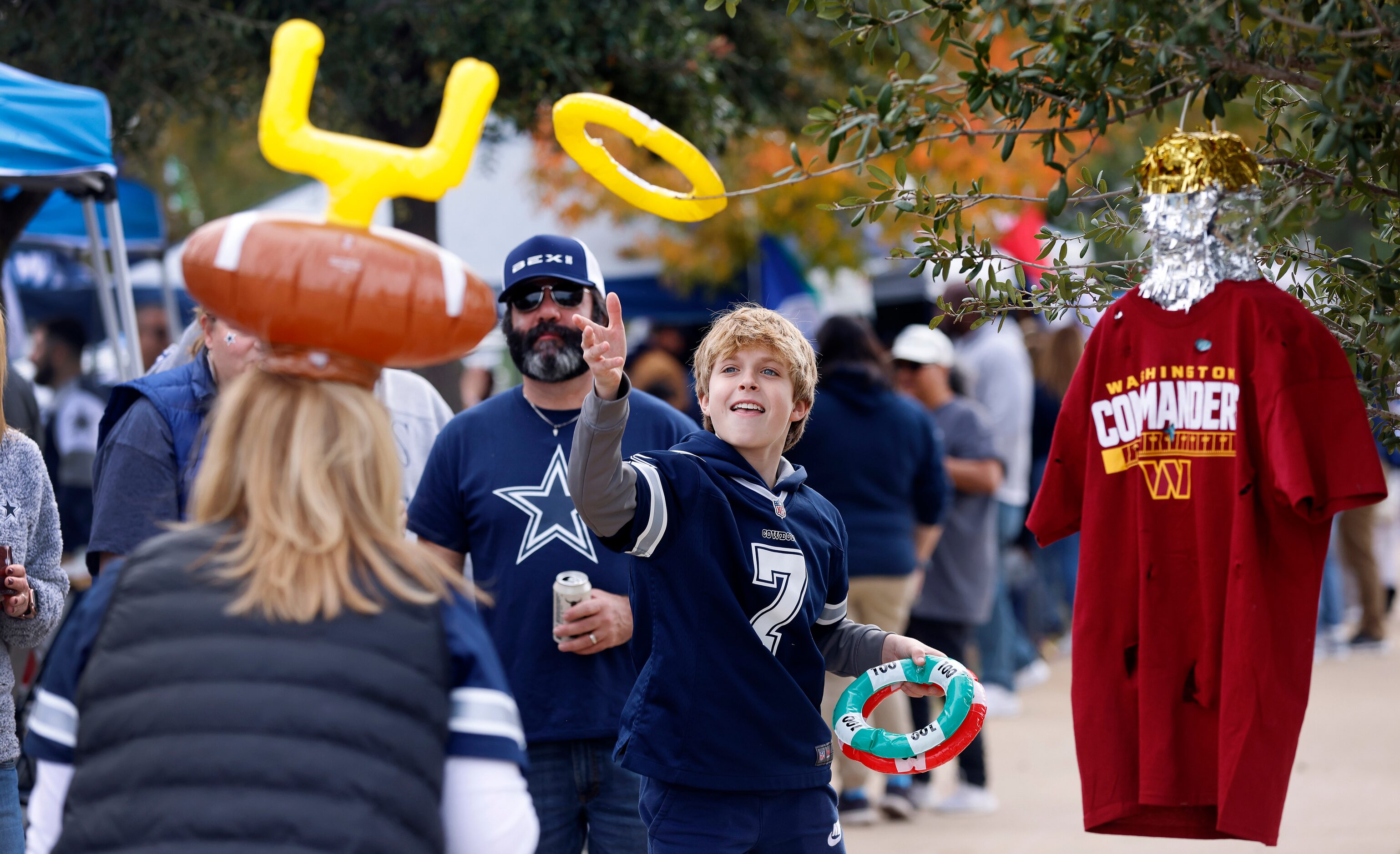 Dallas Cowboys fan Zalan Szelcsanyi, 12 of Arlington tries to throw an inflatable ring...