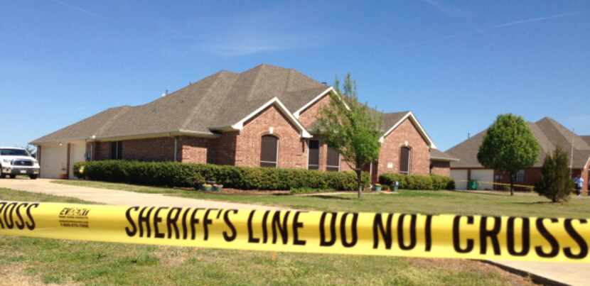 Crime scene tape wraps around the home of Kaufman County District Attorney Mike McLelland...