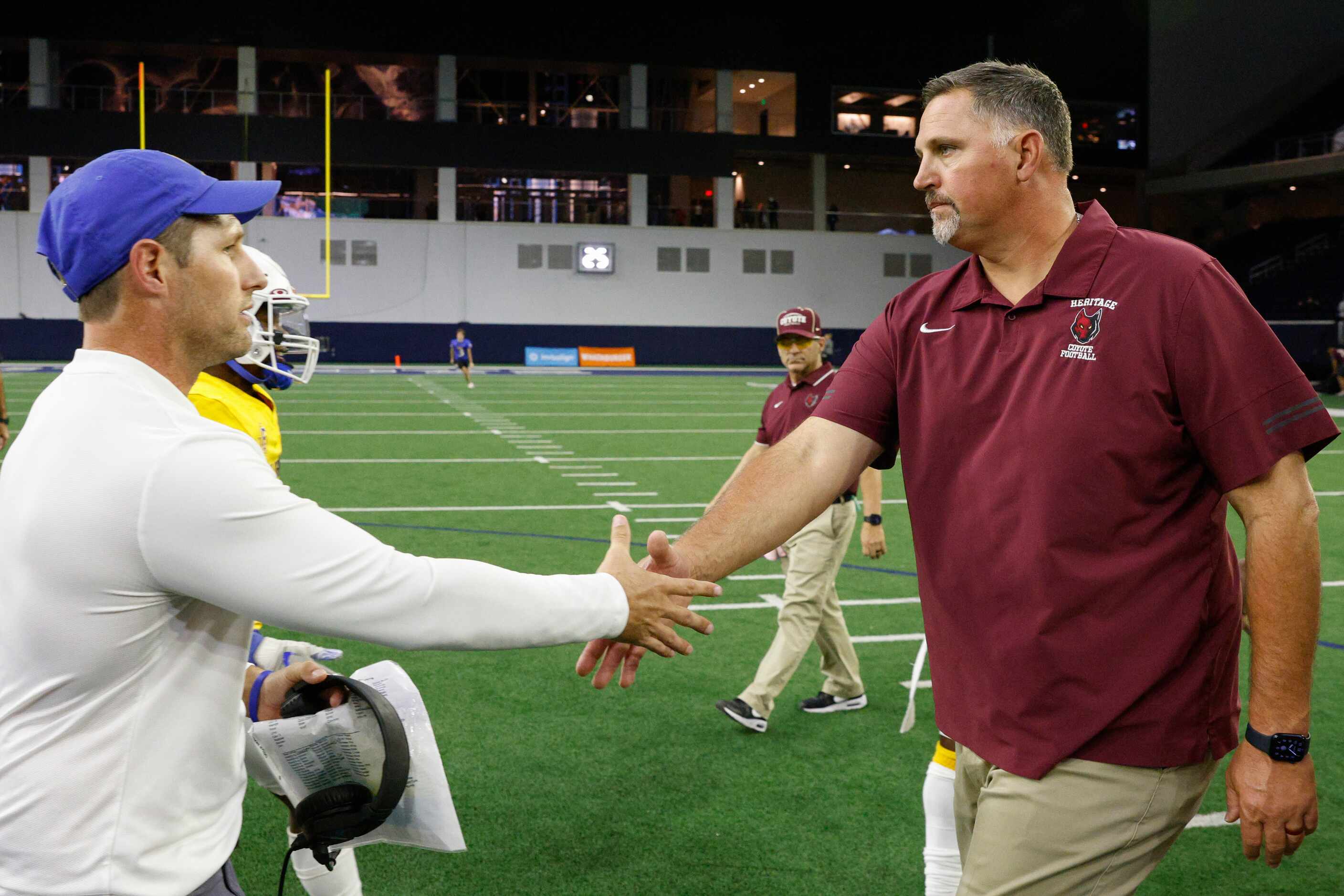Frisco head coach Jeff Harbert (left) shakes hands with Frisco Heritage head coach Kenneth...