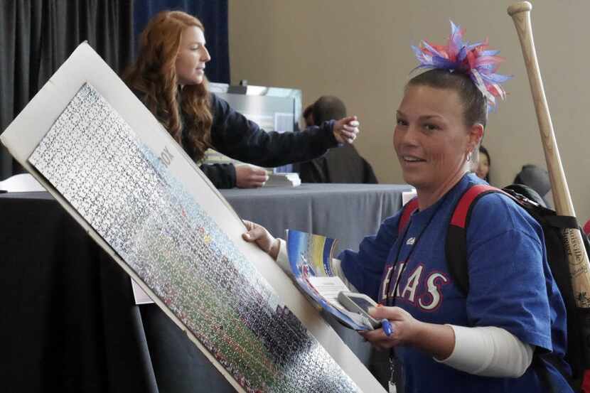 A happy Jamie Cortez, of Tyler, Texas leaves with a 1000 piece puzzle signed by Texas...