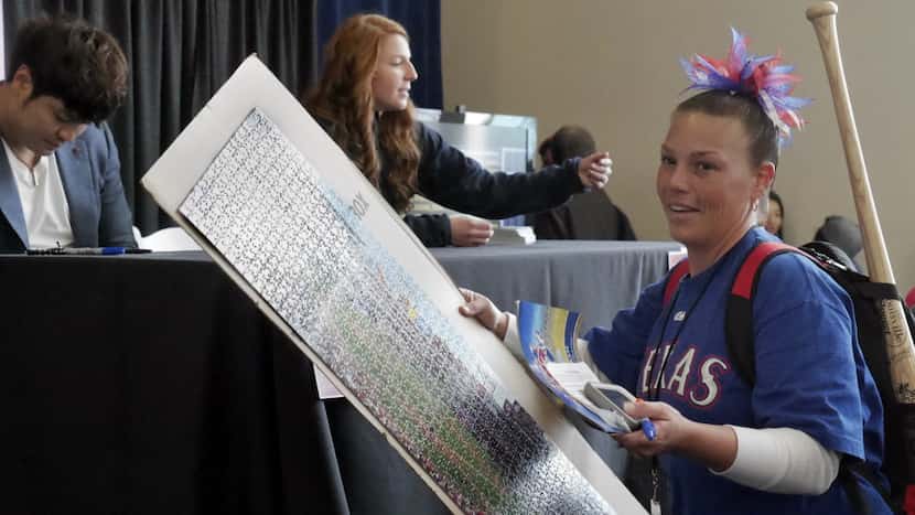 A happy Jamie Cortez, of Tyler, Texas leaves with a 1000 piece puzzle signed by Texas...