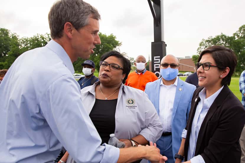 Former congressman Beto O'Rourke shakes state representative Jessica González's hand before...
