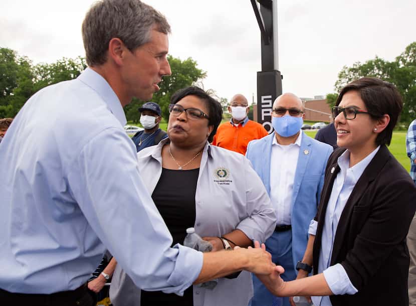 Former congressman Beto O'Rourke shakes state representative Jessica González's hand before...