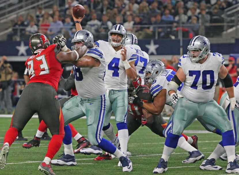 Blocking by Dallas Cowboys offensive linemen Doug Free (68), Tyron Smith (77), Ronald Leary...