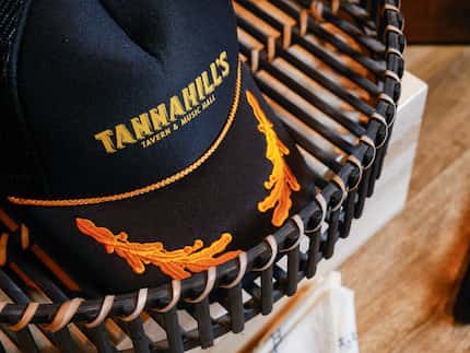 Merchandise from Tannahill's Tavern & Music Hall sits on display among Chef Tim Love’s...