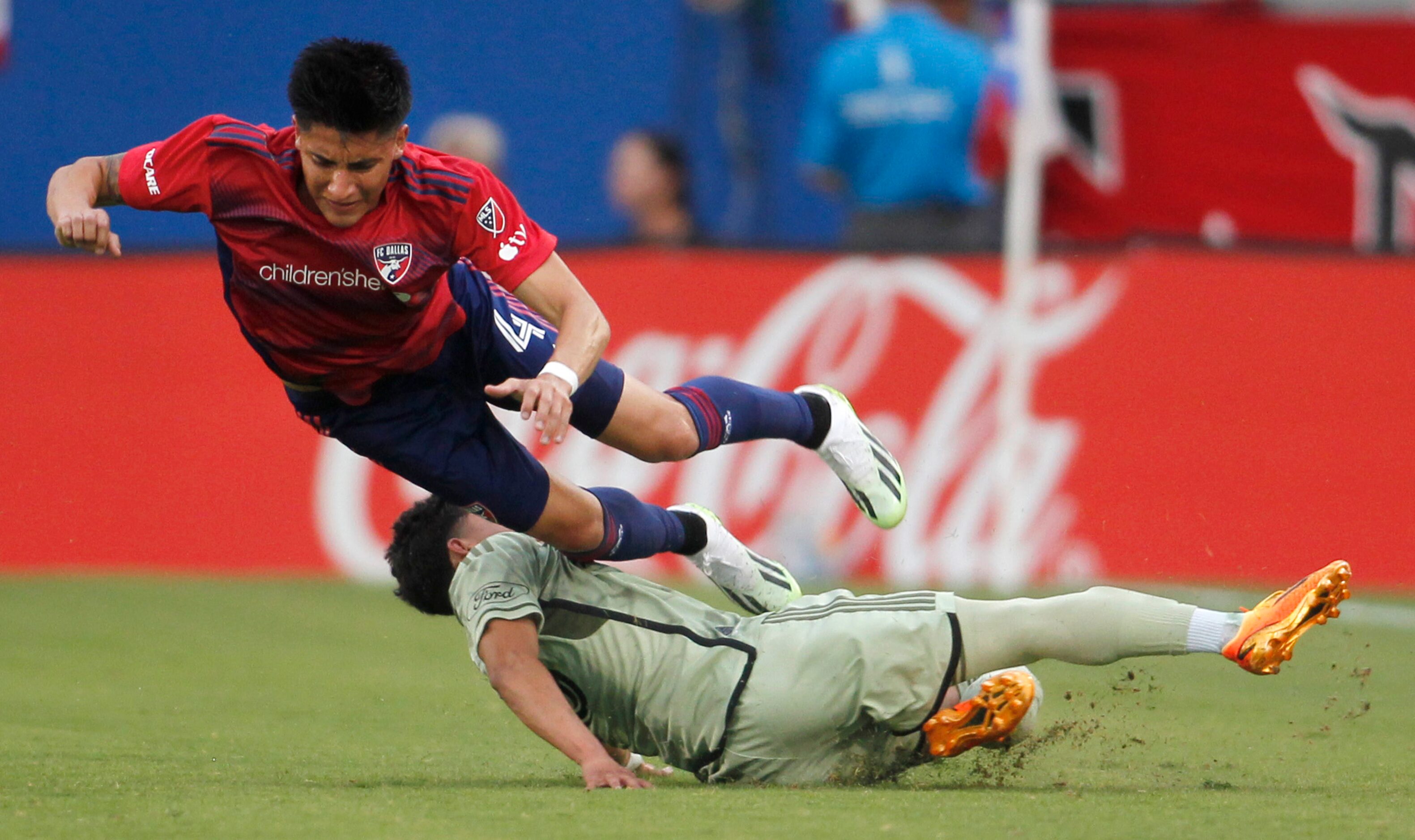 FC Dallas defender Marco Farfan (4) flies over LA FC defender Erik Duenas (18) following a...