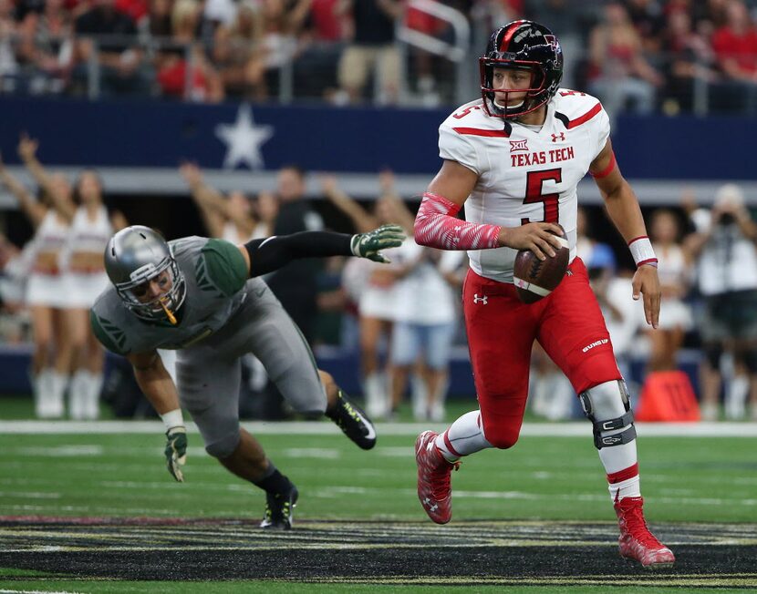 Texas Tech Red Raiders quarterback Patrick Mahomes (5) runs with the ball in the first half...