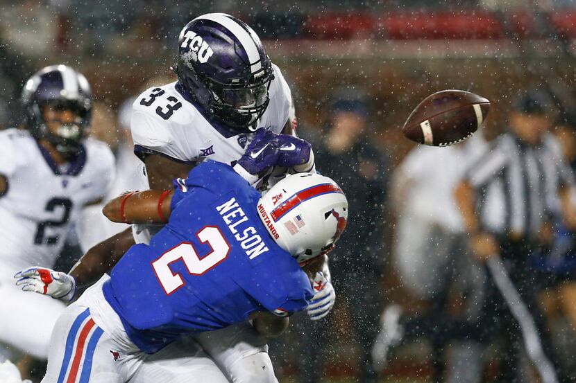 TCU running back Sewo Olonilua (33) fumbles the ball after a hit by SMU safety Patrick...
