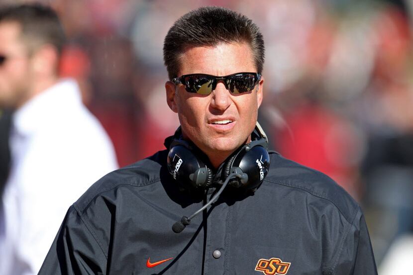 Oct 26, 2013; Ames, IA, USA; Oklahoma State Cowboys head coach Mike Gundy looks on during...