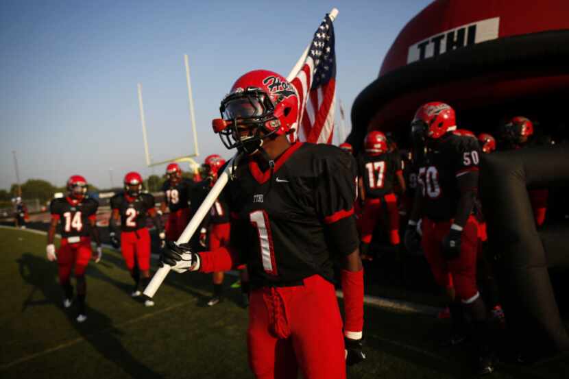 Cedar Hill's Marcus Green (1) waits to take the field with his teammates before a high...