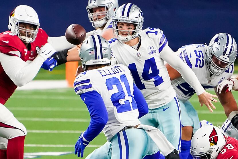 Dallas Cowboys quarterback Andy Dalton (14) gets off a shuffle pass to running back Ezekiel...