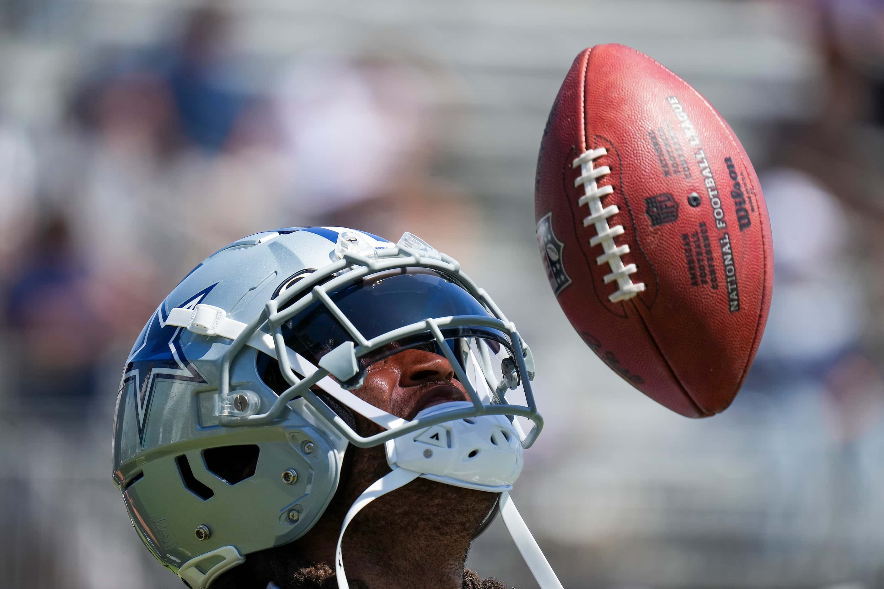 Dallas Cowboys cornerback Stephon Gilmore looks up for a ball tossed from behind his back by...
