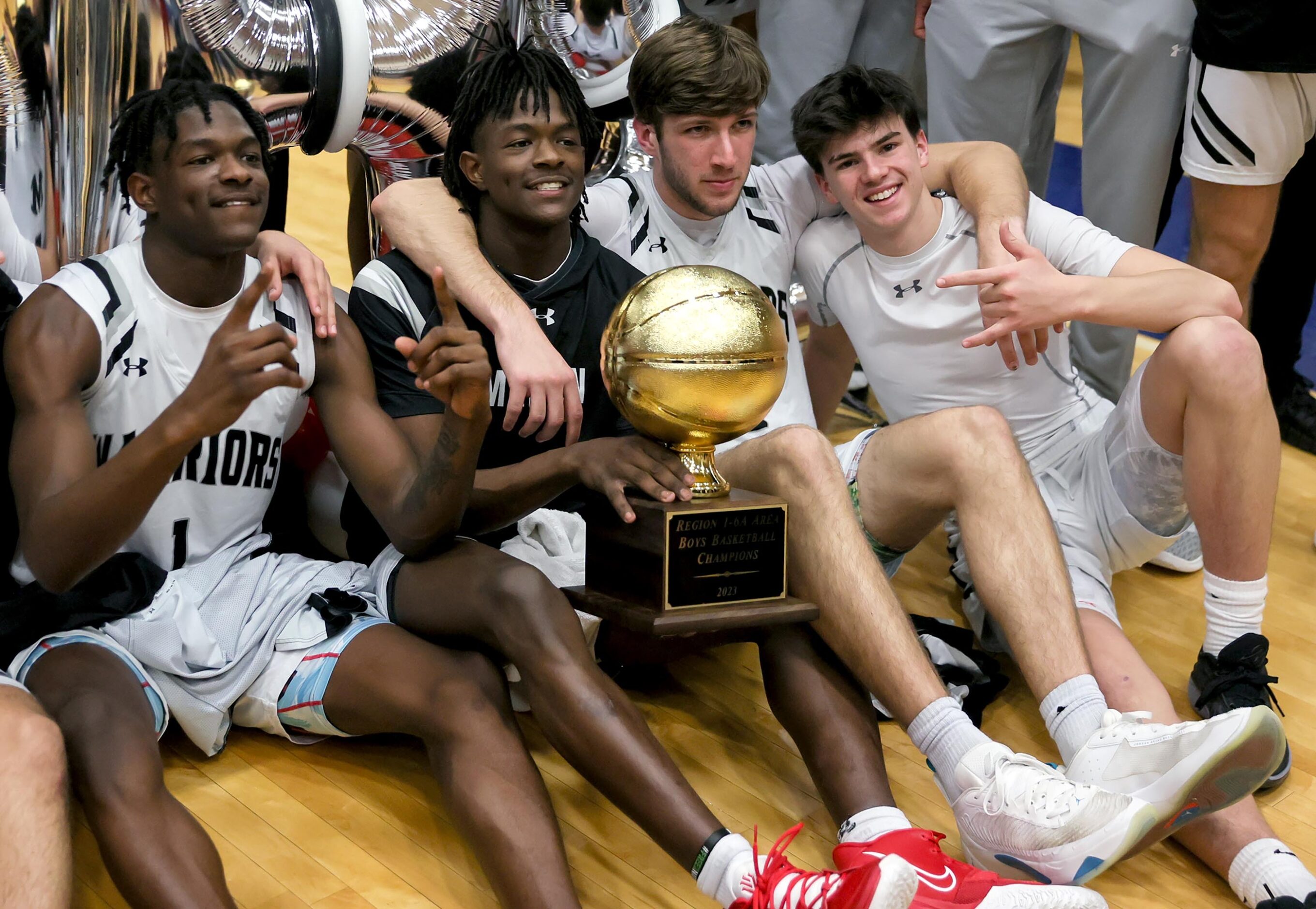 The Arlington Martin Warriors celebrate their victory over Lewisville, 55-53 in a 6A...