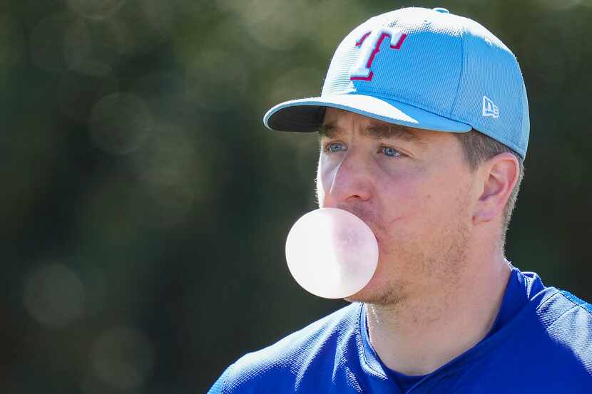 Texas Rangers pitcher Josh Sborz blows a bubble during a spring training workout at the...