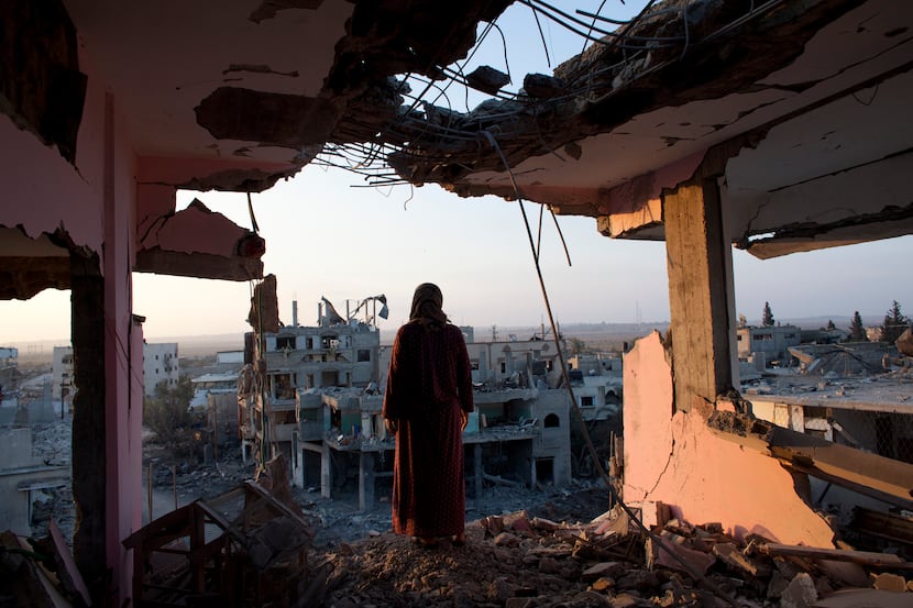 Palestinian woman Hidya Atash overlooks the destruction in Shujayea neighborhood of Gaza...