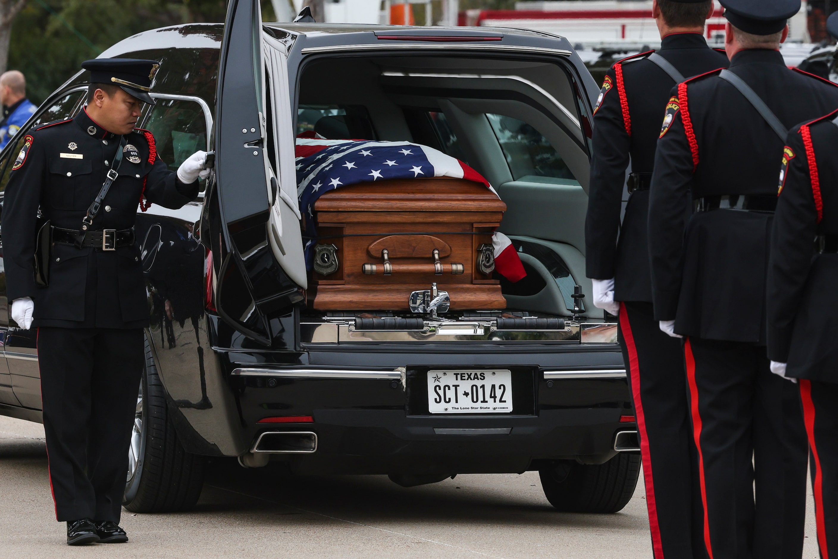 The casket of Grand Prairie police officer Brandon P. Tsai in the back of a hearse, Monday,...