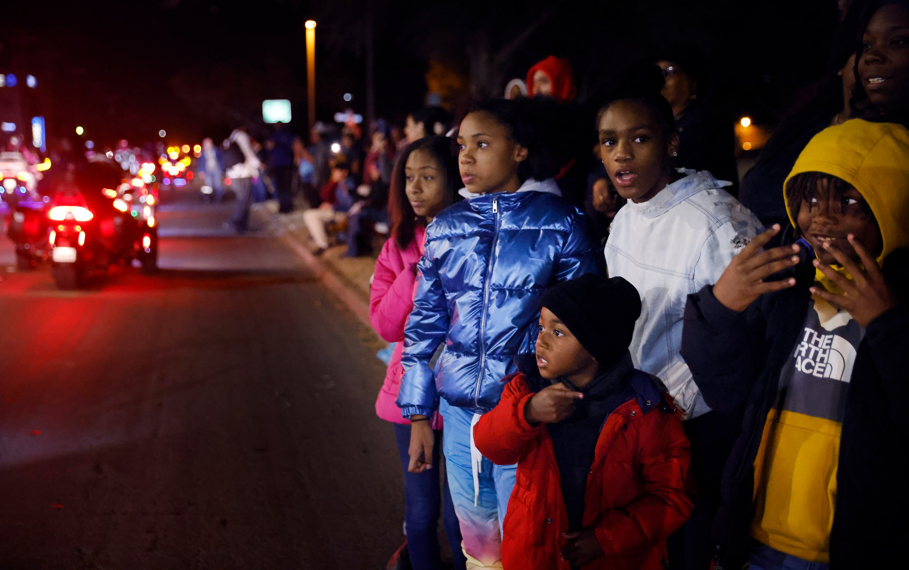 Kids watch a celebratory parade around Armstrong Park in Duncanville, January 13, 2023. In...