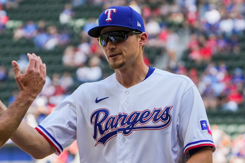 Texas Rangers shortstop Corey Seager shakes hands with teammates as he is introduced before...