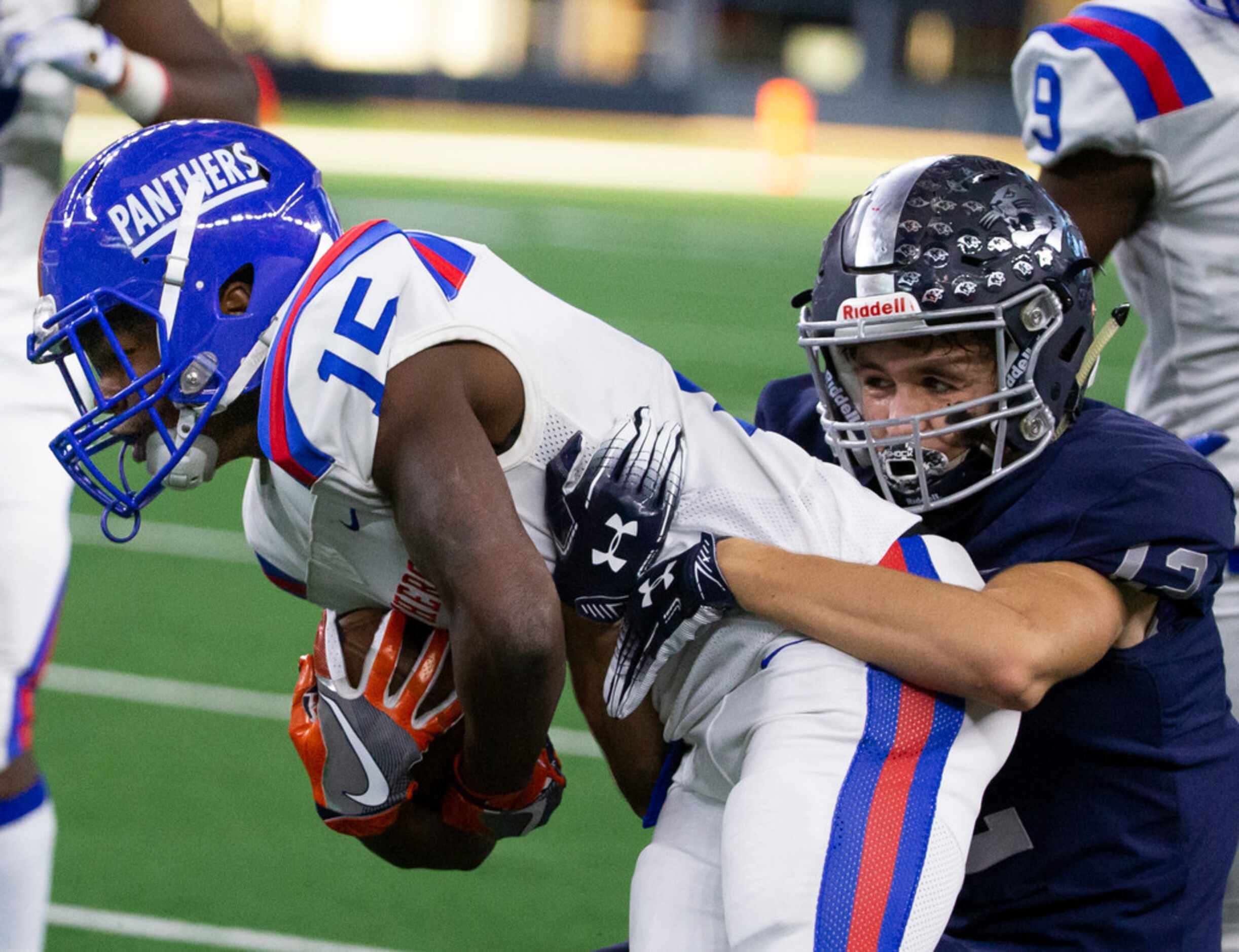 Duncanville defensive back James Roberts Jr. tries to escape the pull of Flower Mound...
