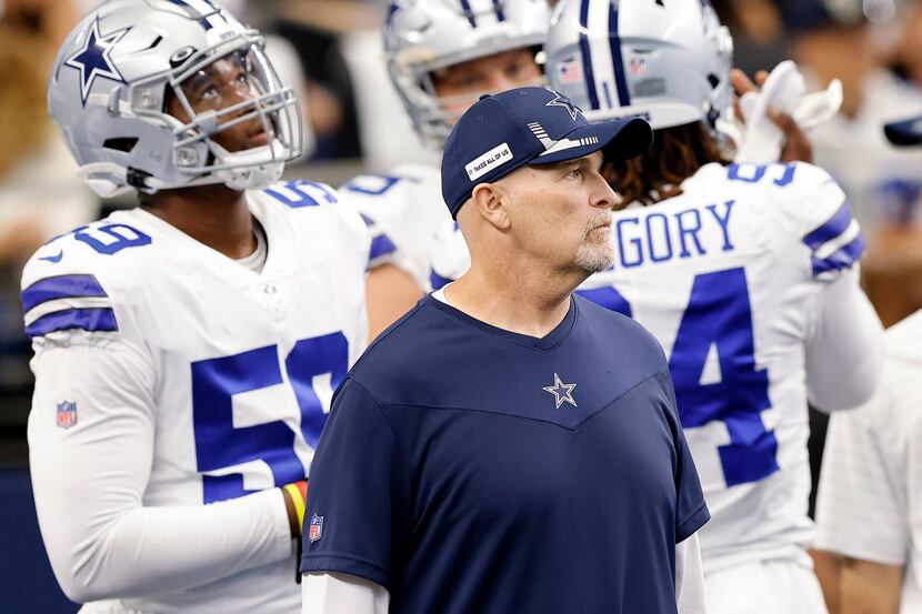 Dallas Cowboys defensive coordinator Dan Quinn watches his squad warmup before facing the...