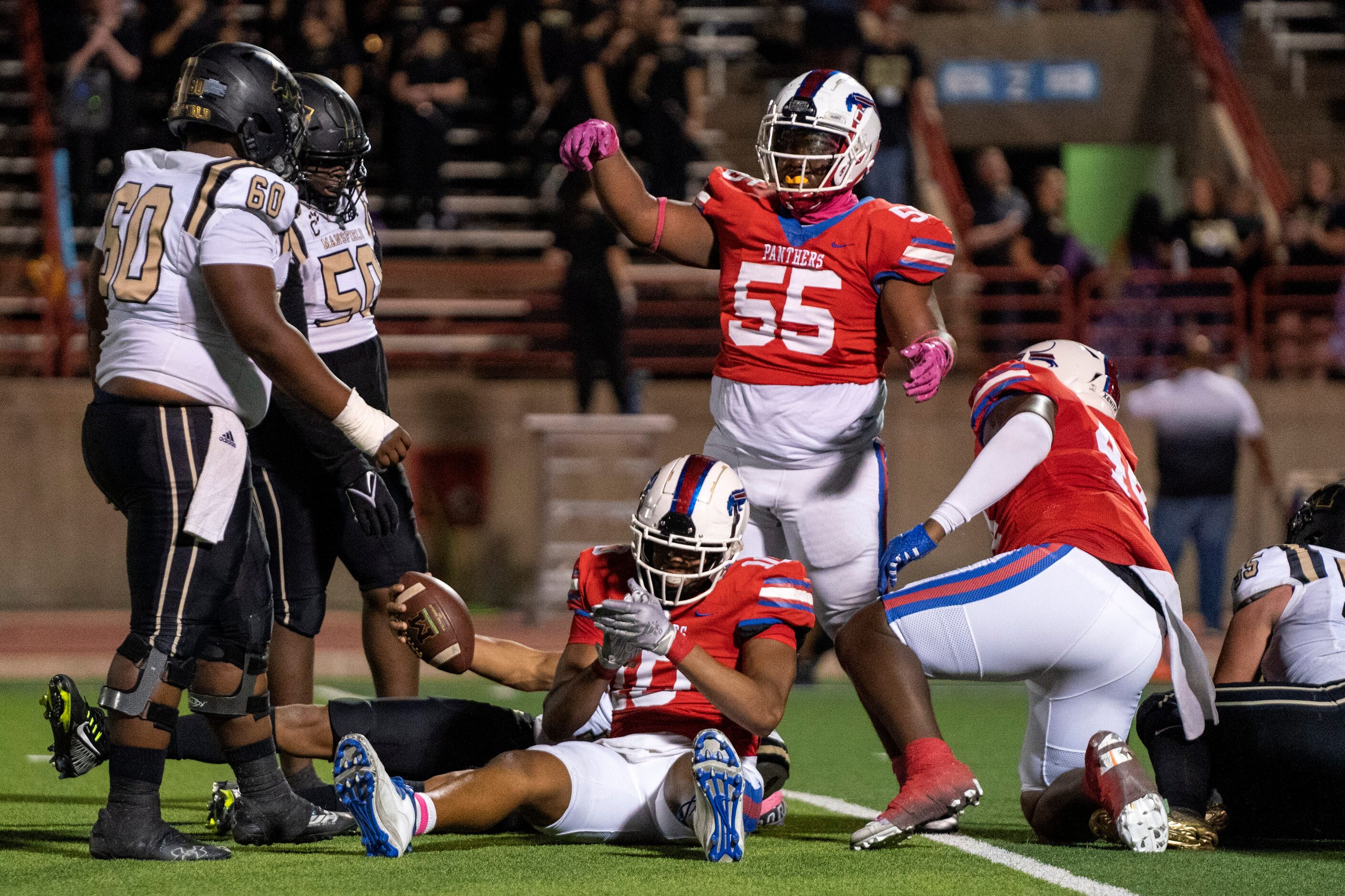 Duncanville senior defensive linemen Jabreohn Peters (55), Kei’Tron Simpson (10), and...