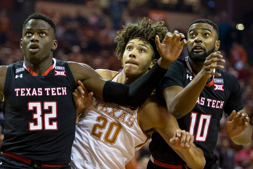 Texas forward Jericho Sims (20) fights for position with Texas Tech center Norense Odiase...