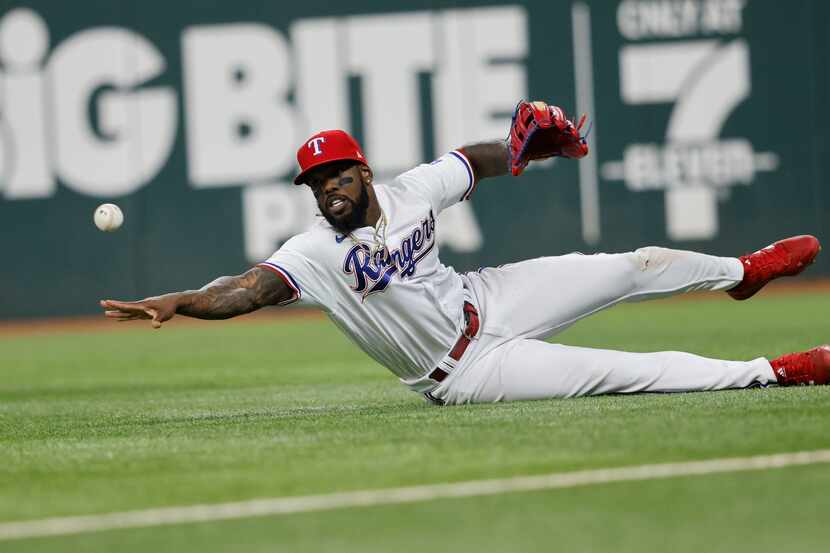 Texas Rangers right fielder Adolis Garcia (53) throws a ball after catching a fly ball hit...