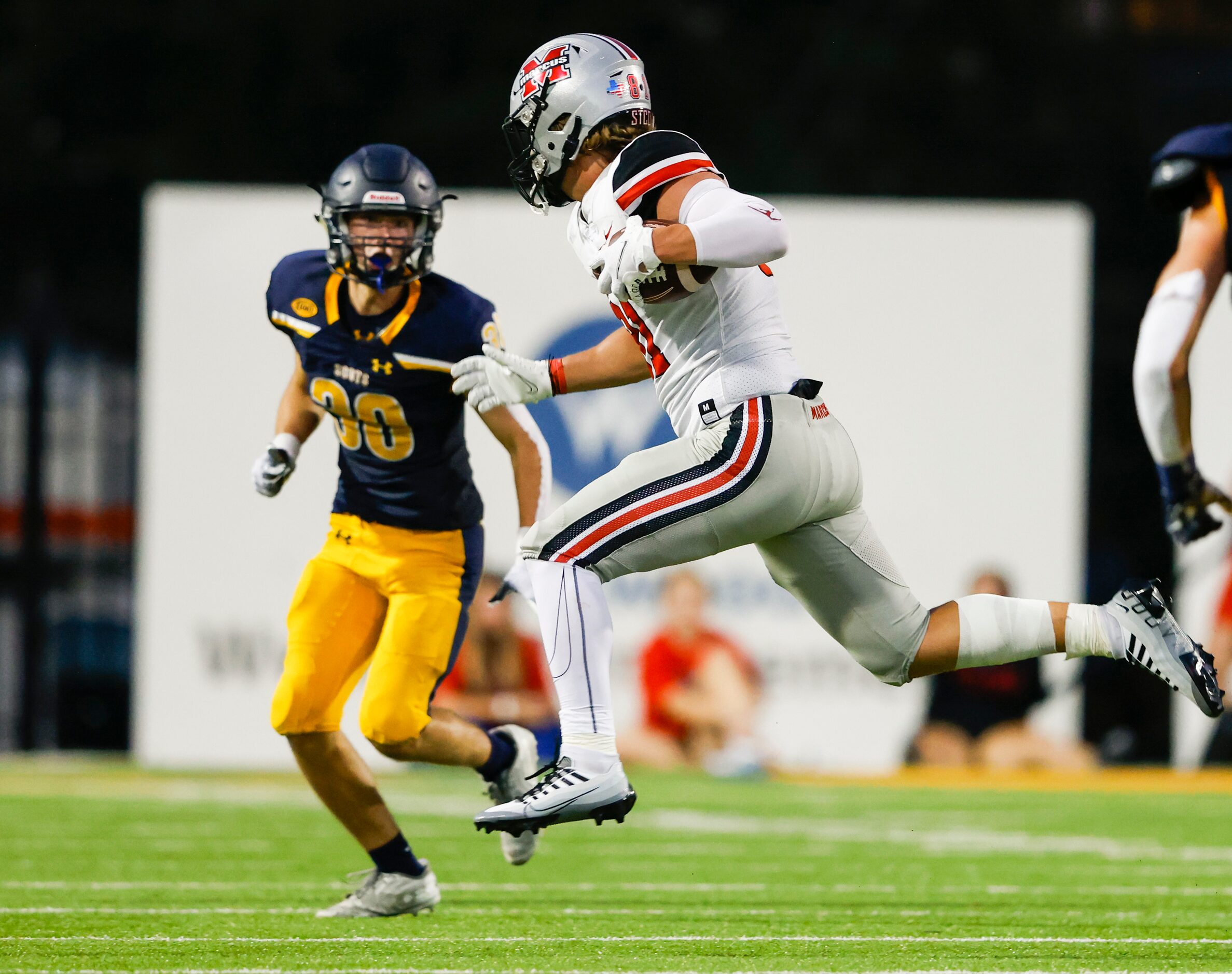 Flower Mound Marcus tight end Aiden Grummer (81) runs against Highland Park defensive back...