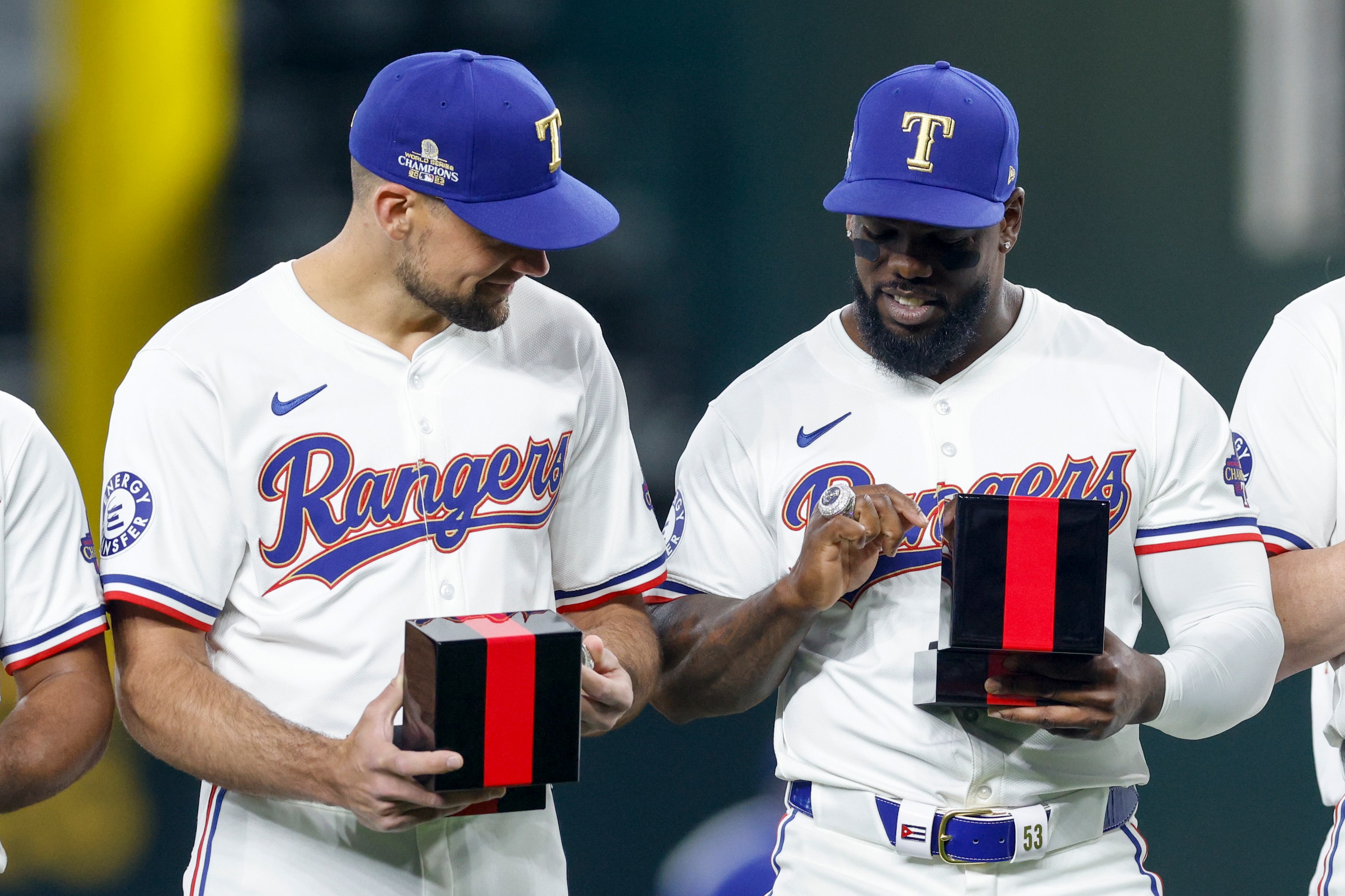 Texas Rangers starting pitcher Nathan Eovaldi (left) and right fielder Adolis Garcia check...