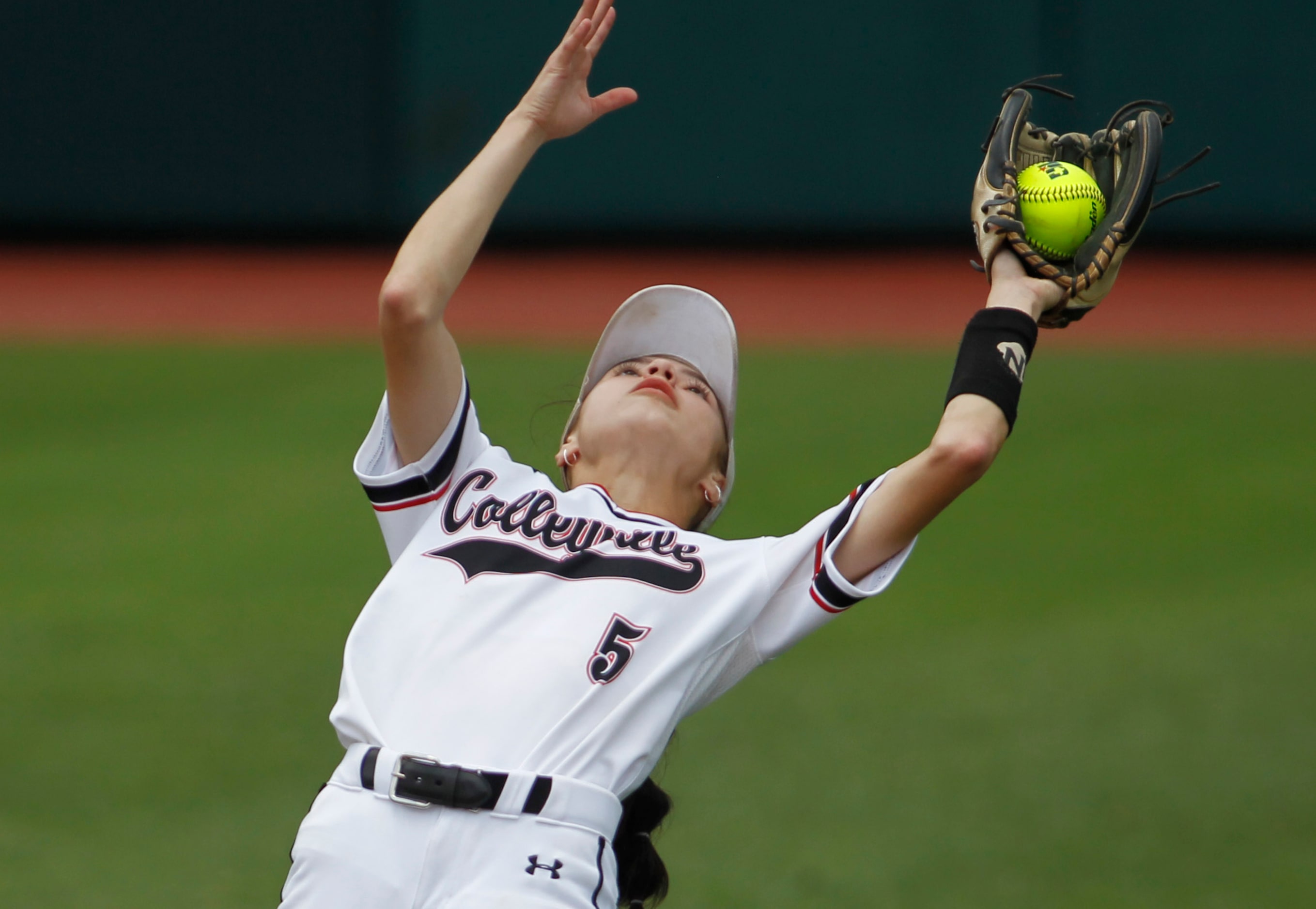 Colleyville Heritage left fielder  Leah Perales (5) pulls in a high fly ball  during the...