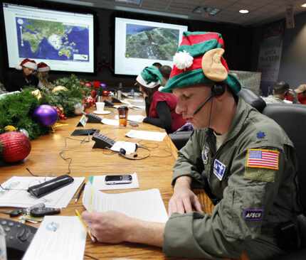 Air Force Lt. Col. David Hanson of Chicago takes a phone call from a child in Florida at the...
