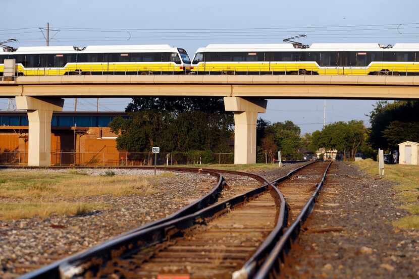 A DART Red Line train passes over a set of tracks near 12th Street and Avenue K in Plano....