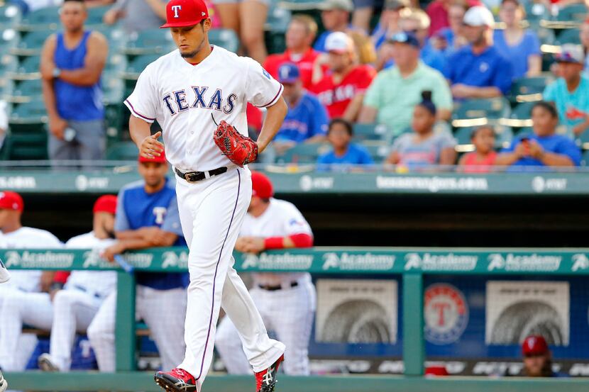 Texas Rangers starting pitcher Yu Darvish runs to the mound to face the Miami Marlins in the...