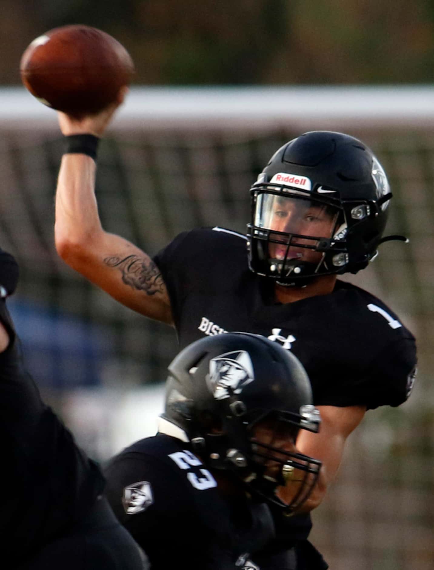 Bishop Lynch quarterback Michael Light (1) releases a pass behind the protection of running...