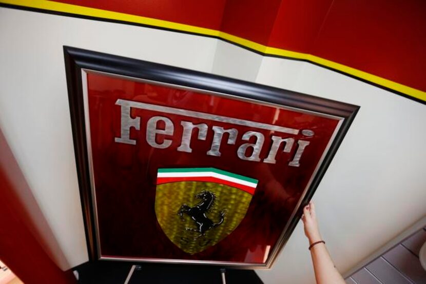 
Boutique manager Sara Marques arranges a piece of custom Ferrari artwork by Plano artist...