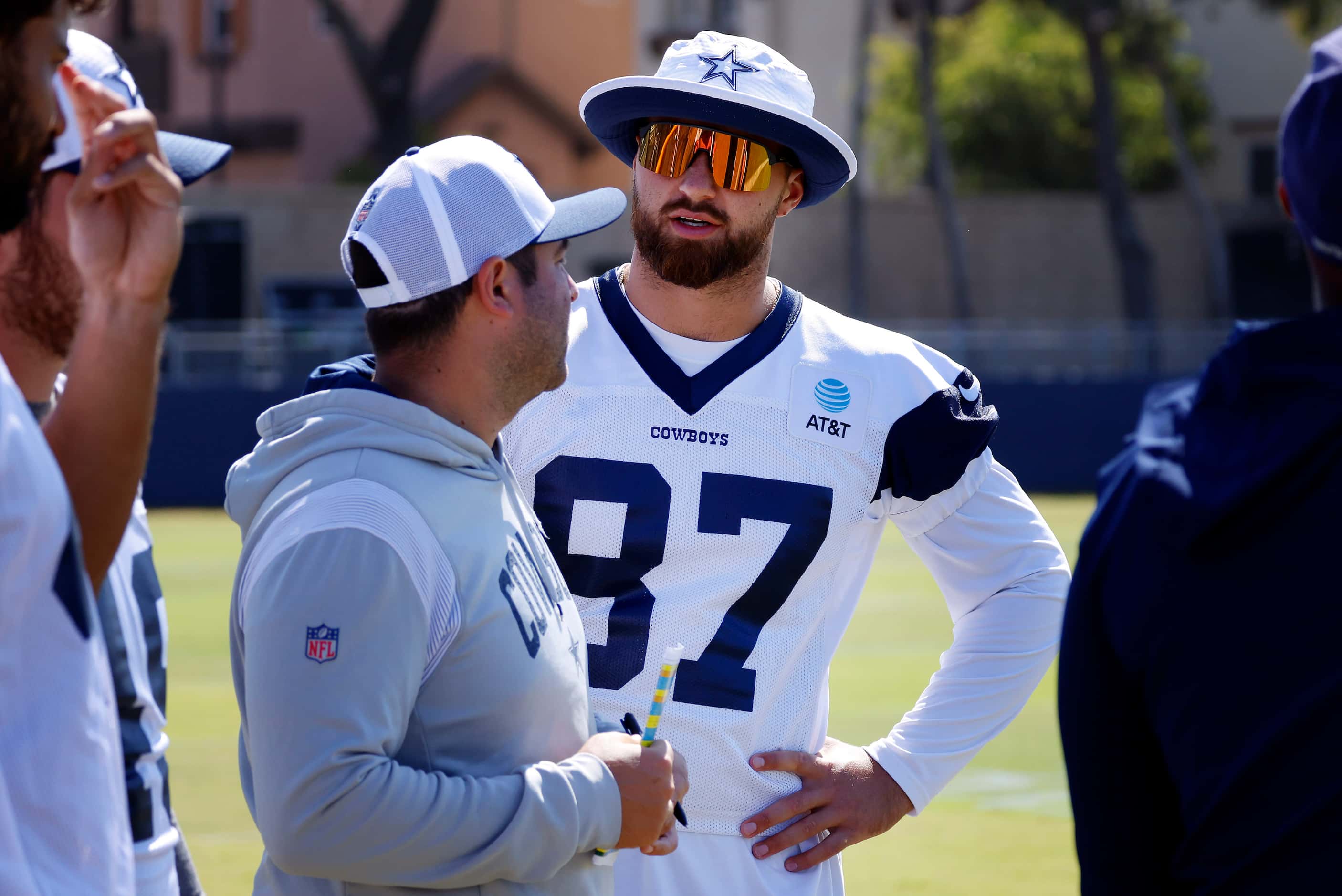 Dallas Cowboys tight end Jake Ferguson (87) visits with personal on the sideline during a...